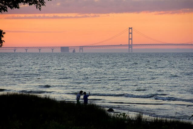 Photo of a schooner crossing in front of the Mackinac Bridge from the shore of Mackinaw Mill Creek Camping in Mackinaw City, MI. © 2016 Frank Rogala.