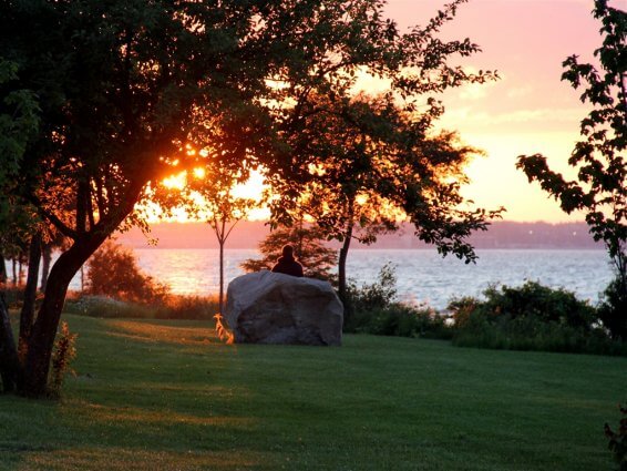 Photo of a camper by a big rock during sunset at Mackinaw Mill Creek Camping in Mackinaw City, MI. © 2016 Frank Rogala.