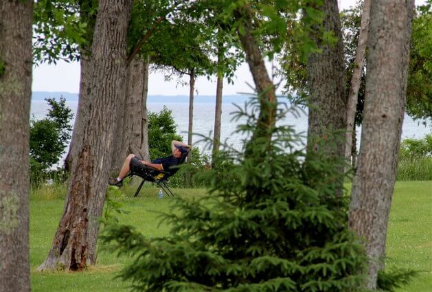 Photo of a camper in a zero gravity chair at Mackinaw Mill Creek Camping in Mackinaw City, MI. © 2016 Frank Rogala.