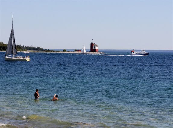 Photo of swimmers in the mouth of Mackinac Island Harbor viewing the Round Island Lighthouse. © 2016 Frank Rogala.