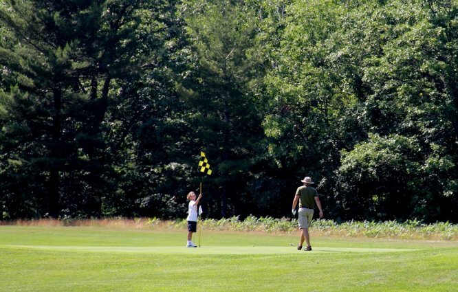 Photo of golfers on a green at the Mackinaw Club Golf Course in Carp Lake, MI. © 2016 Frank Rogala.