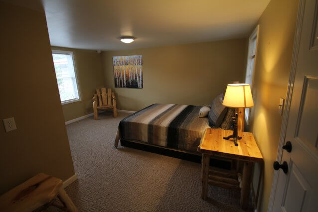 Motel bedroom with wooden bed frame (1 of 2). © 2017 Frank Rogala.