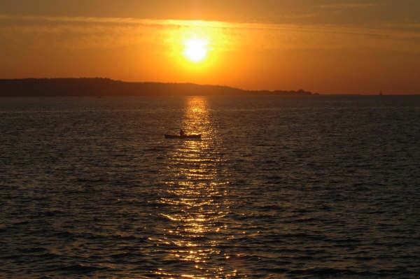 Photo of man in a canoe by Chad Swanson at Mackinaw Mill Creek Camping in Mackinaw City, MI.