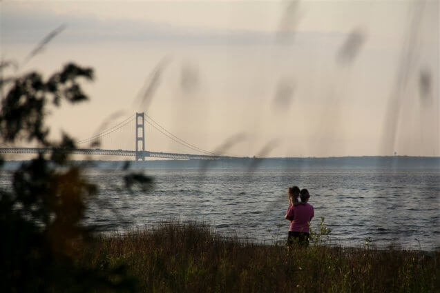 Photo of campers viewing the Mackinac Bridge from Mackinaw Mill Creek Camping ni Mackinaw City, MI. © 2016 Frank Rogala.