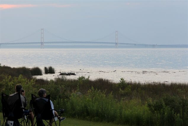 Photo of campers enjoying the view of the Mackinac Bridge during twilight at Mackinaw Mill Creek Camping in Mackinaw City, MI. © 2016 Frank Rogala.