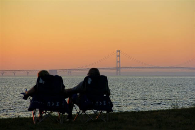 Photo of a couple watching the sunset over the Mackinac Bridge from Mackinaw Mill Creek Camping in Mackinaw City, MI. © 2016 Frank Rogala.