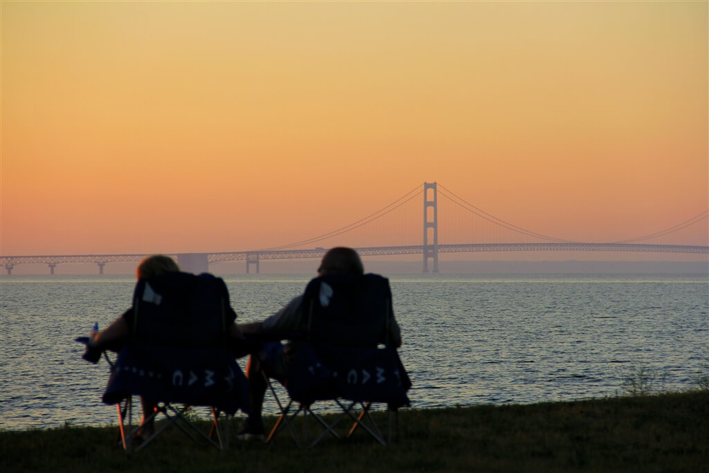 Photo of a couple watching the sunset over the Mackinac Bridge from Mackinaw Mill Creek Camping in Mackinaw City, MI. © 2016 Frank Rogala.