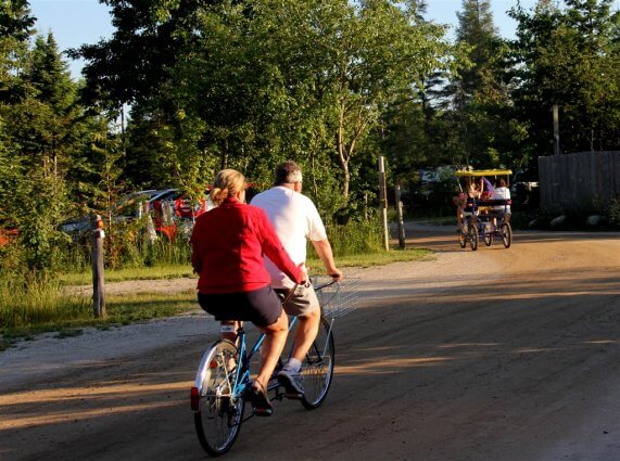 Photo of campers riding a bicycle built for two at Mackinaw Mill Creek Camping in Mackinaw City, MI. © 2016 Frank Rogala.