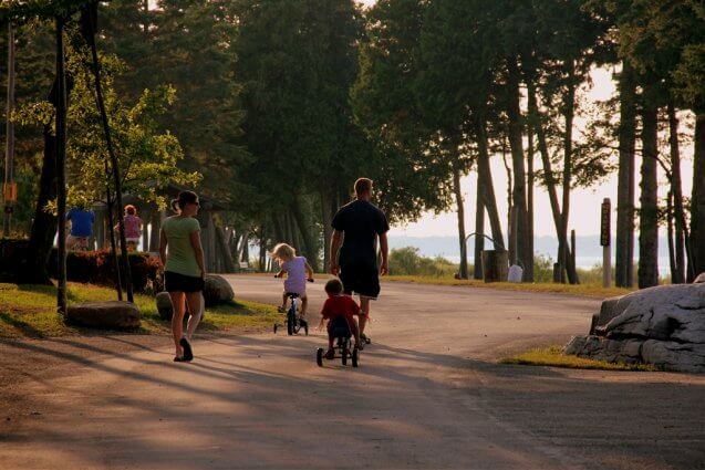 Photo of campers taking a stroll near Big Rock at Mackinaw Mill Creek Camping in Mackinaw City, MI. © 2016 Frank Rogala.