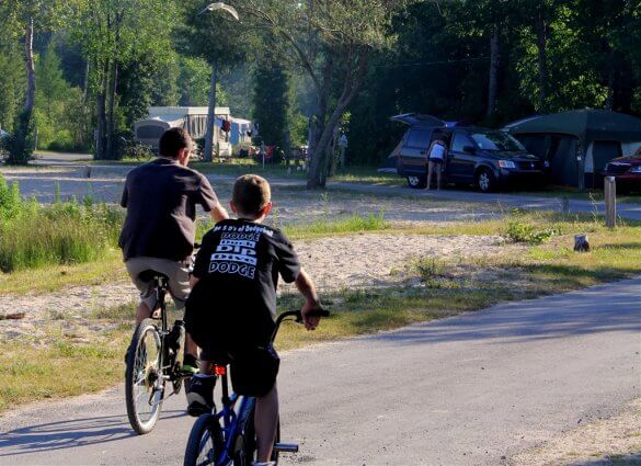 Photo of campers riding bikes at Mackinaw Mill Creek Camping in Mackinaw City, MI. © 2016 Frank Rogala.