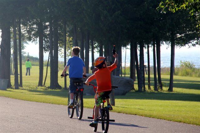 Photo of children riding their bikes at Mackinaw Mill Creek Camping in Mackinaw City, MI. © 2016 Frank Rogala.