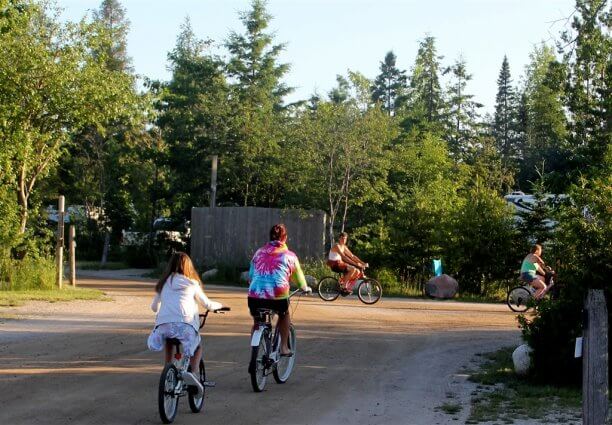 Photo of campers riding bikes near the large RV area at Mackinaw Mill Creek Camping in Mackinaw City, MI. © 2016 Frank Rogala.