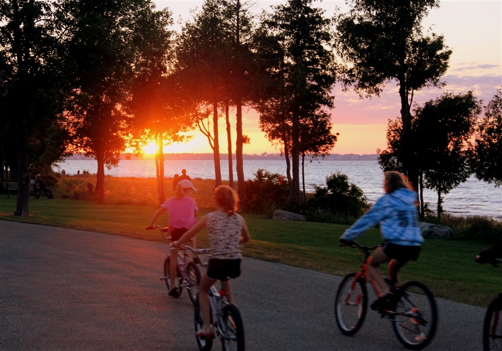 Photo of campers riding bikes at sunset at Mackinaw Mill Creek Camping in Mackinaw City, MI. © 2016 Frank Rogala.