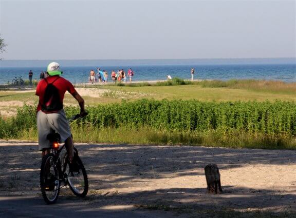 Photo of a bicylcist on the shoreline of Mackinaw Mill Creek Camping in Mackinaw City, MI. © 2016 Frank Rogala.