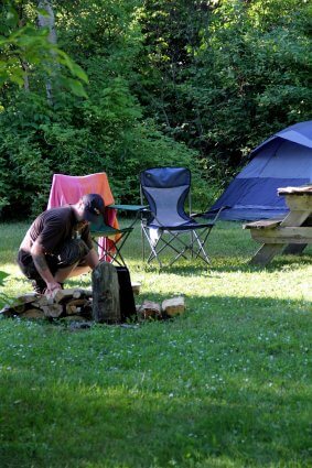 Photo of a camper building a campfire at Mackinaw Mill Creek Camping in Mackinaw City, MI. © 2016 Frank Rogala.
