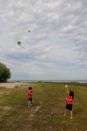 Photo of people flying kites at Mackinaw Mill Creek Camping in Mackinaw City, MI. © 2016 Frank Rogala.