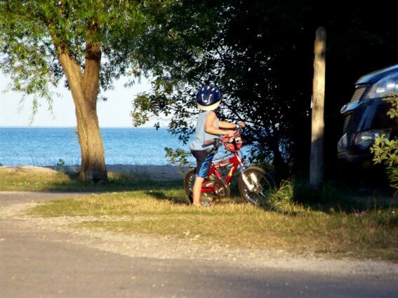 Photo of a child riding his bike at Mackinaw Mill Creek Camping in Mackinaw City, MI. © 2016 Frank Rogala.