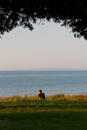 Photo of a camper finding solitude on the shores of Mackinaw Mill Creek Camping in Mackinaw City, MI. © 2016 Frank Rogala.