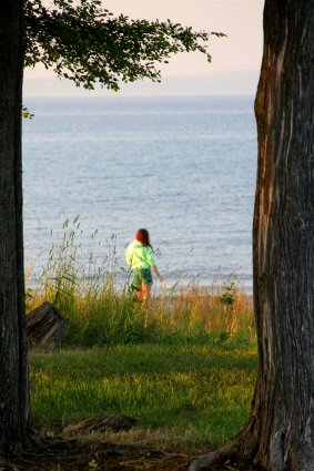 Photo of camper walking along the shores of Mackinaw Mill Creek Camping in Mackinaw City, MI. © 2016 Frank Rogala.