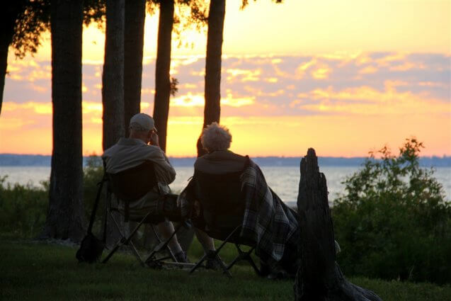 Photo of campers under a blanket viewing a sunset from Mackinaw Mill Creek Camping in Mackinaw City, MI. © 2016 Frank Rogala.