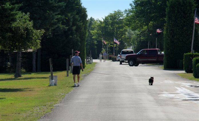 Photo of camper walking his dog at Mackinaw Mill Creek Camping in Mackinaw City, MI. © 2016 Frank Rogala.