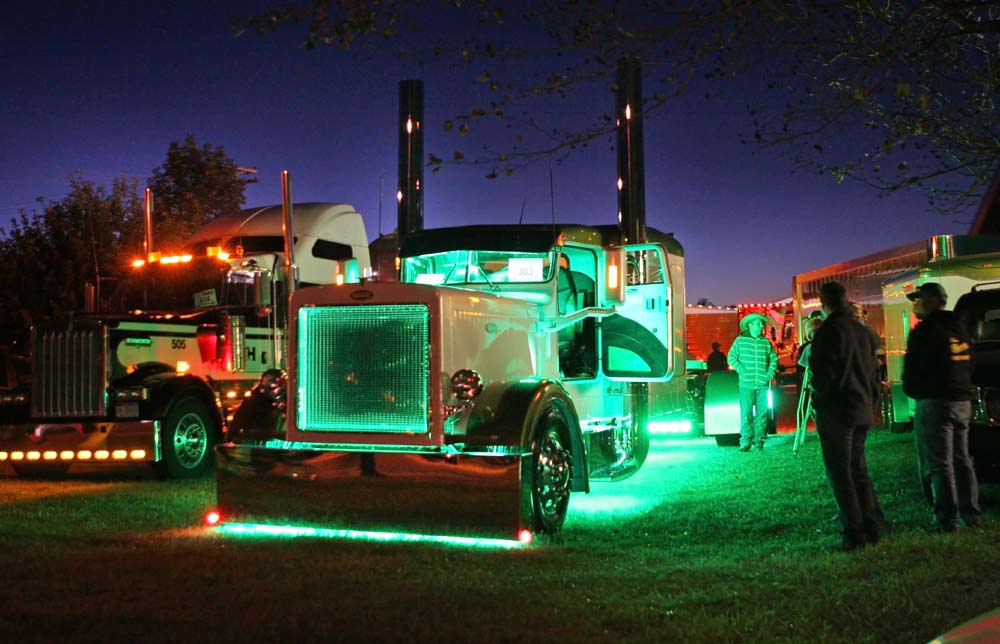 Photo of trucks lighted up atnight at the Richard Crane Memorial Truck Show. Image source: nostalgia-prod.com.