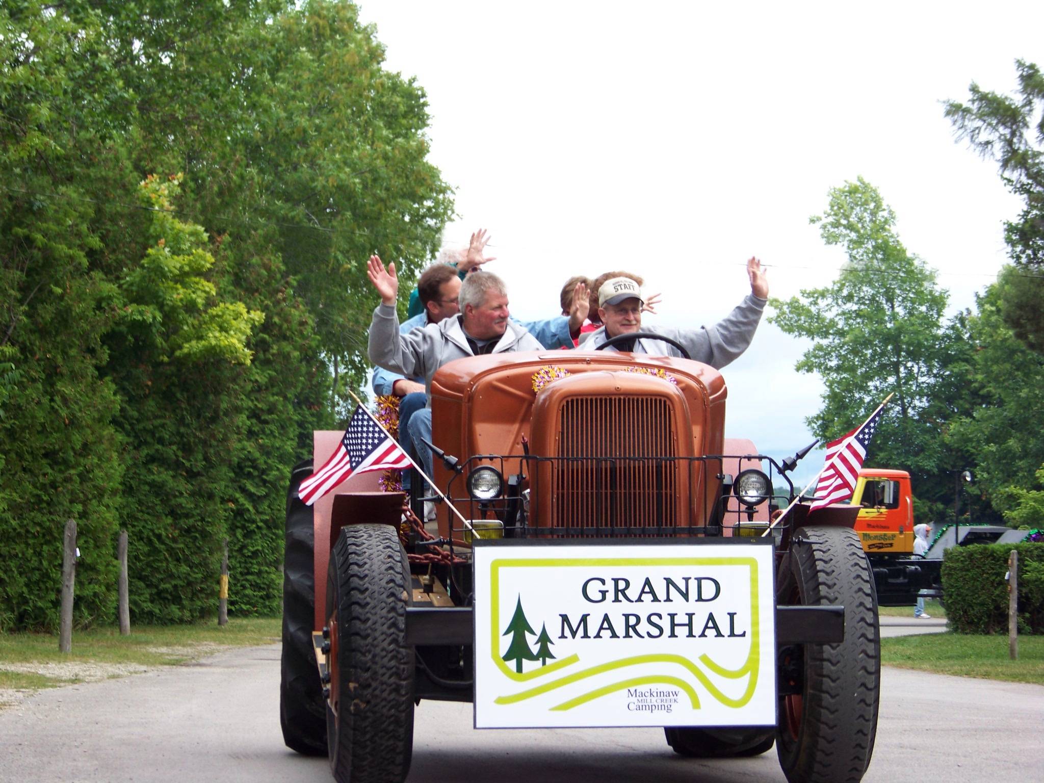 Grand Marshal on a Ford tractor at Mackinaw Mill Creek Camping's 50th Anniversary celebration parade. Copyright (©) 2014 Mackinaw Mill Creek Camping and Frank Rogala. All rights reserved.